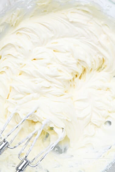 Fluffy cream cheese frosting after mixing with hand mixer.