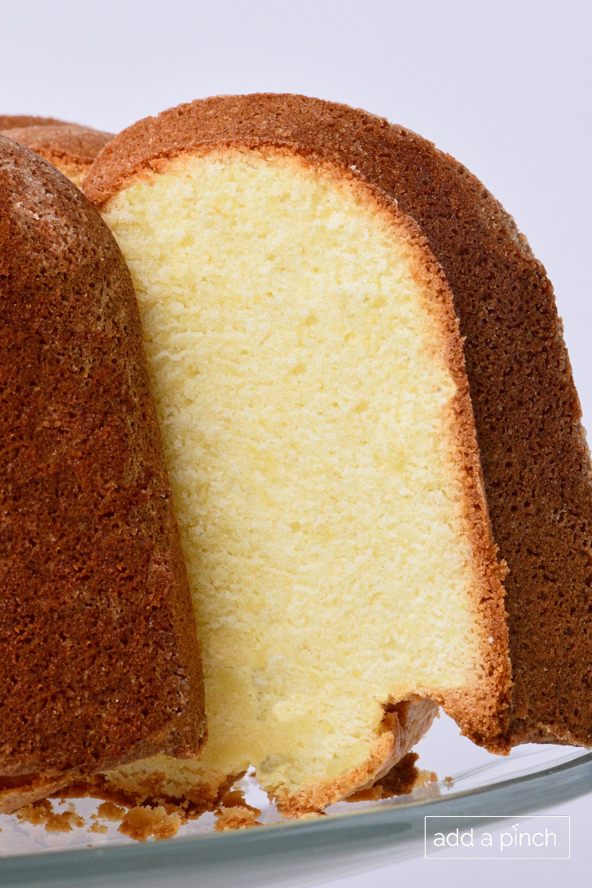 Cream cheese pound cake with slice removed to show velvety inside.  