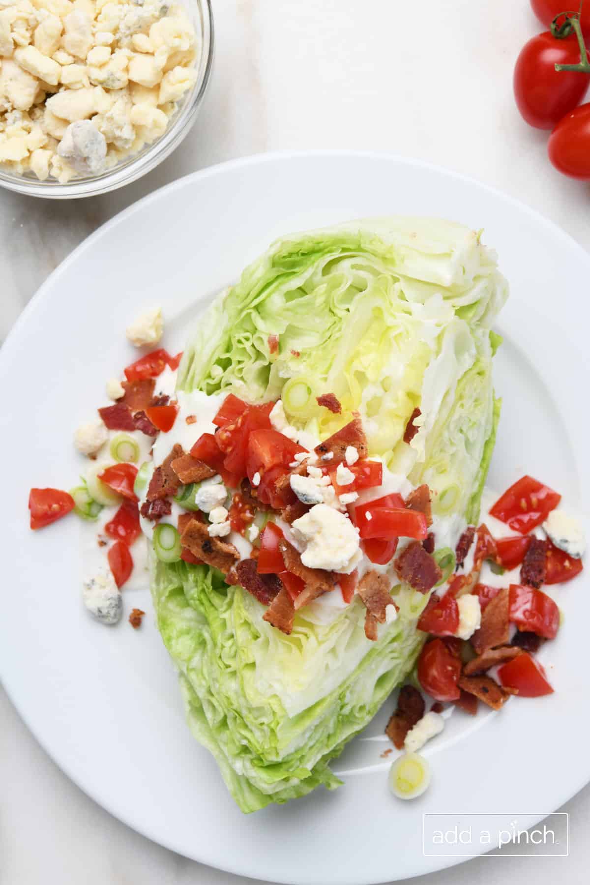 Wedge salad with bacon, tomatoes, and blue cheese.