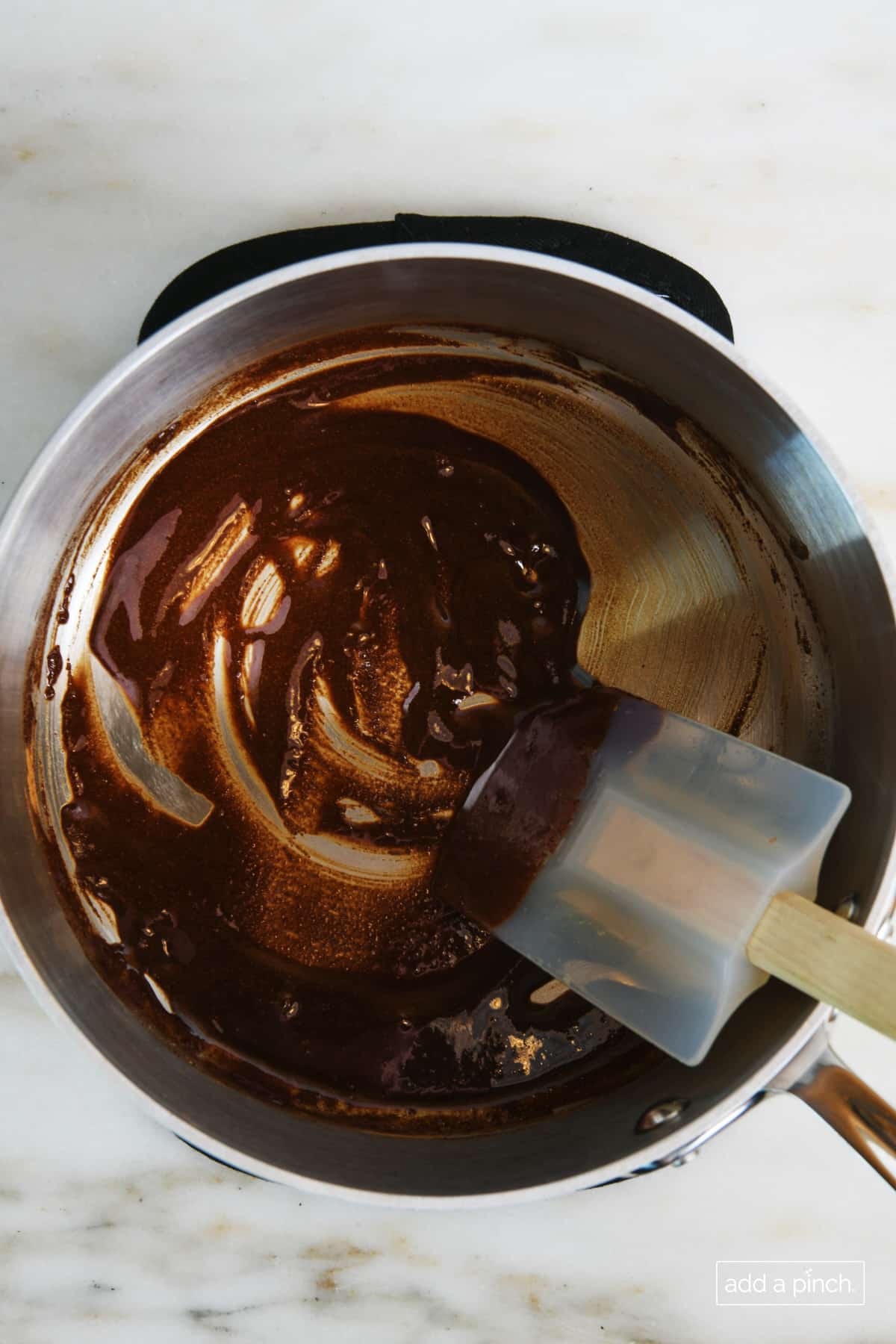 Butter and cinnamon melted in a saucepan and stirred with a rubber spatula.