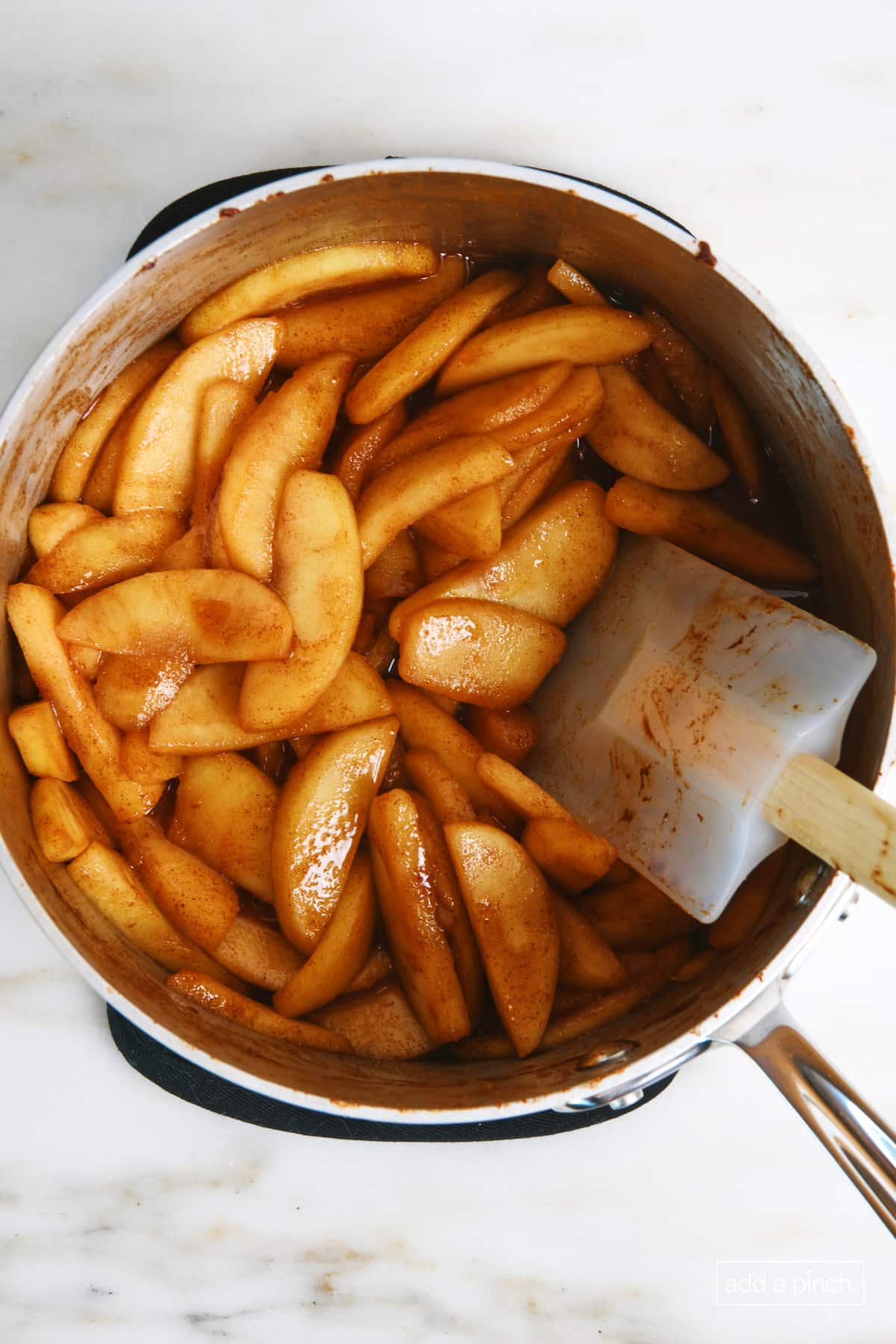 Overhead view of apple pie filling after it has cooked in a saucepan.