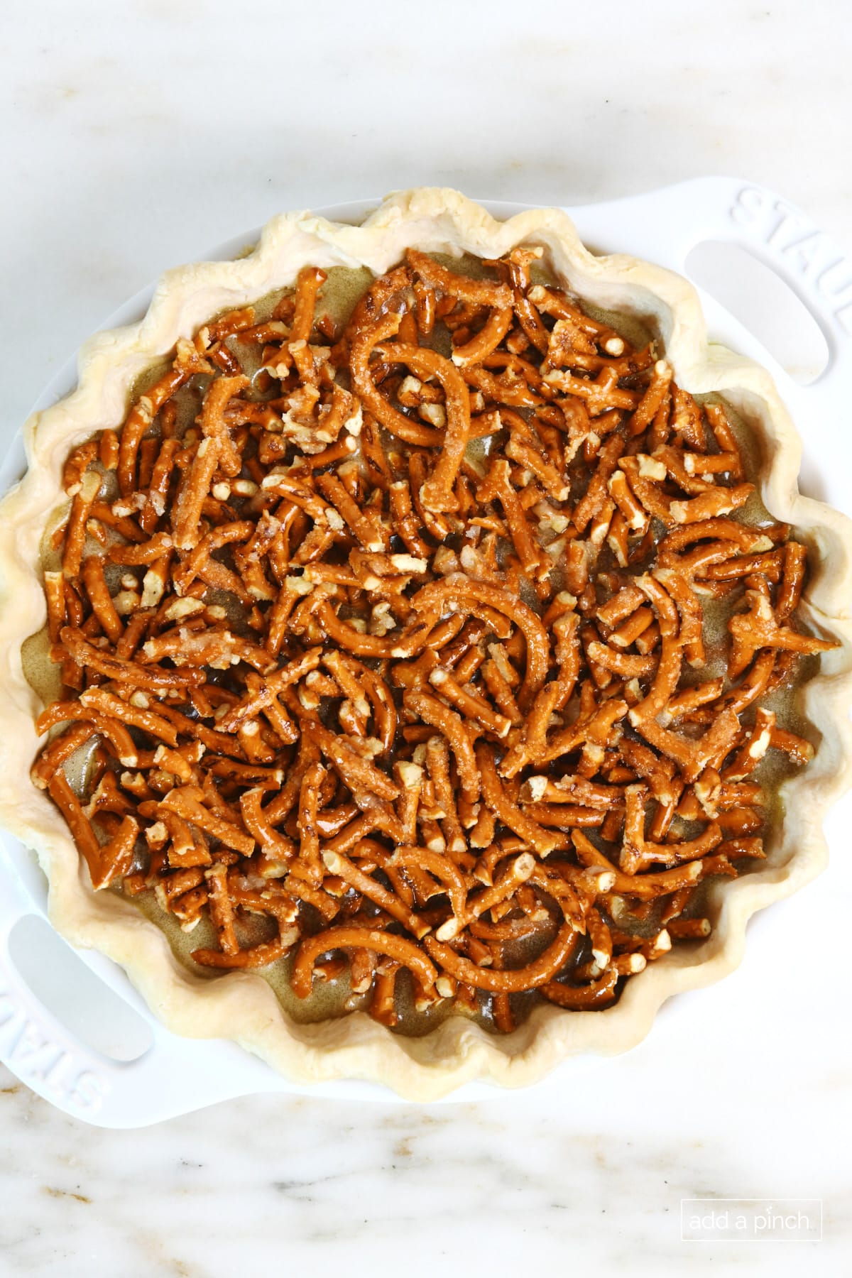 Unbaked mock pecan pie on a marble counter.