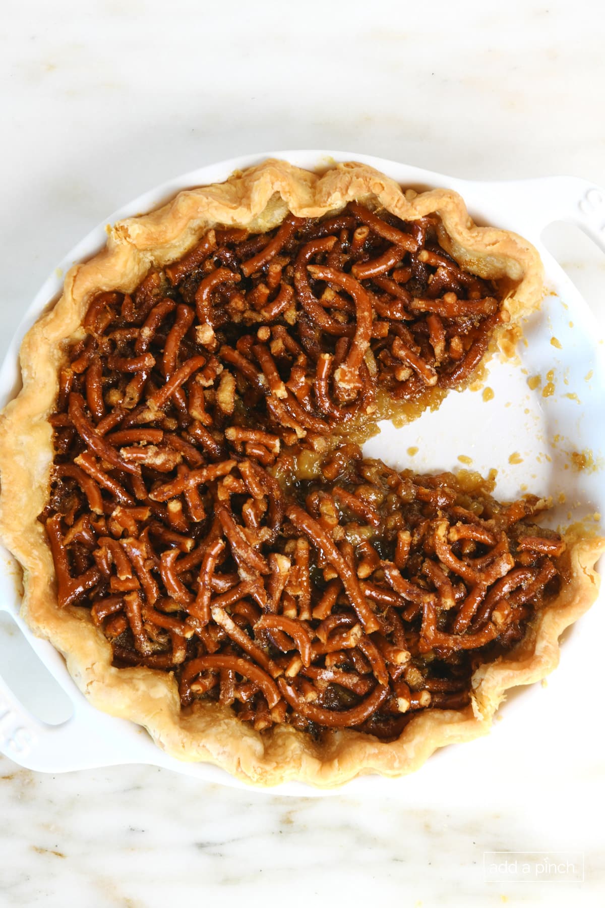 Baked mock pecan pie recipe on a marble surface.