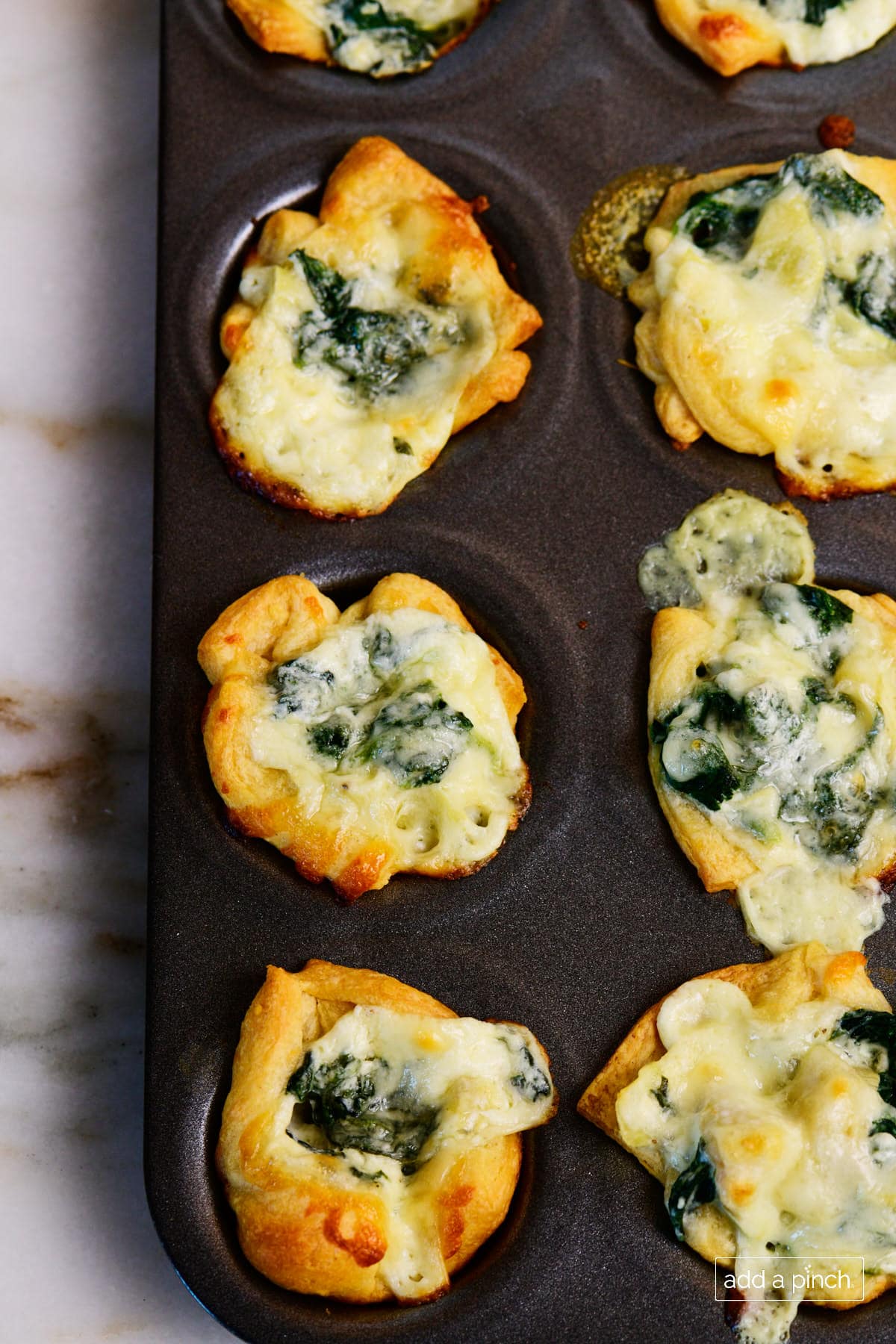 Pan of baked spinach dip bites. 