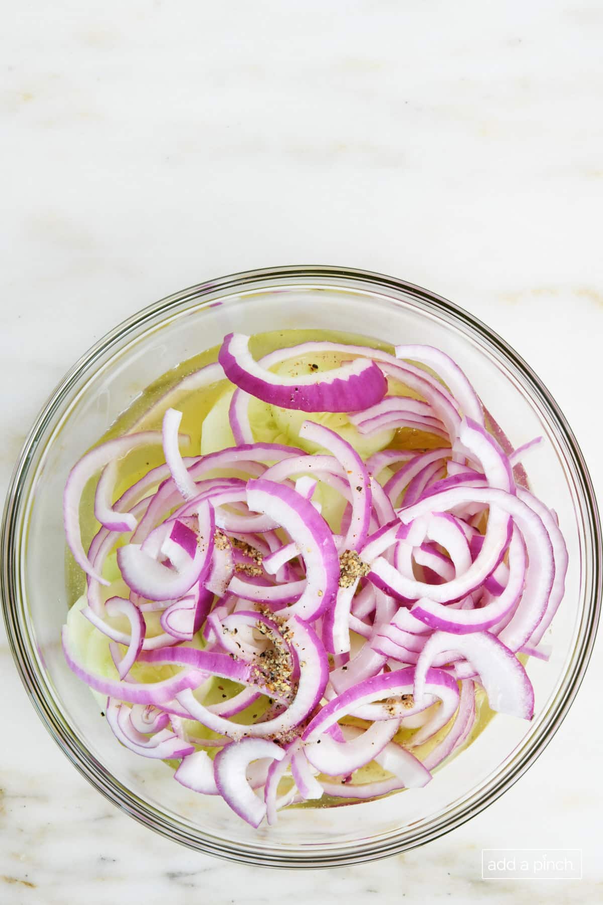 Vinegar dressing has been added to the cucumber onion salad.