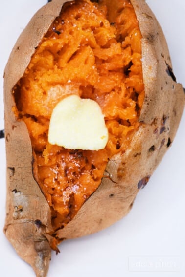Air Fryer Sweet Potato opened with a pat of butter and sprinkle of salt.