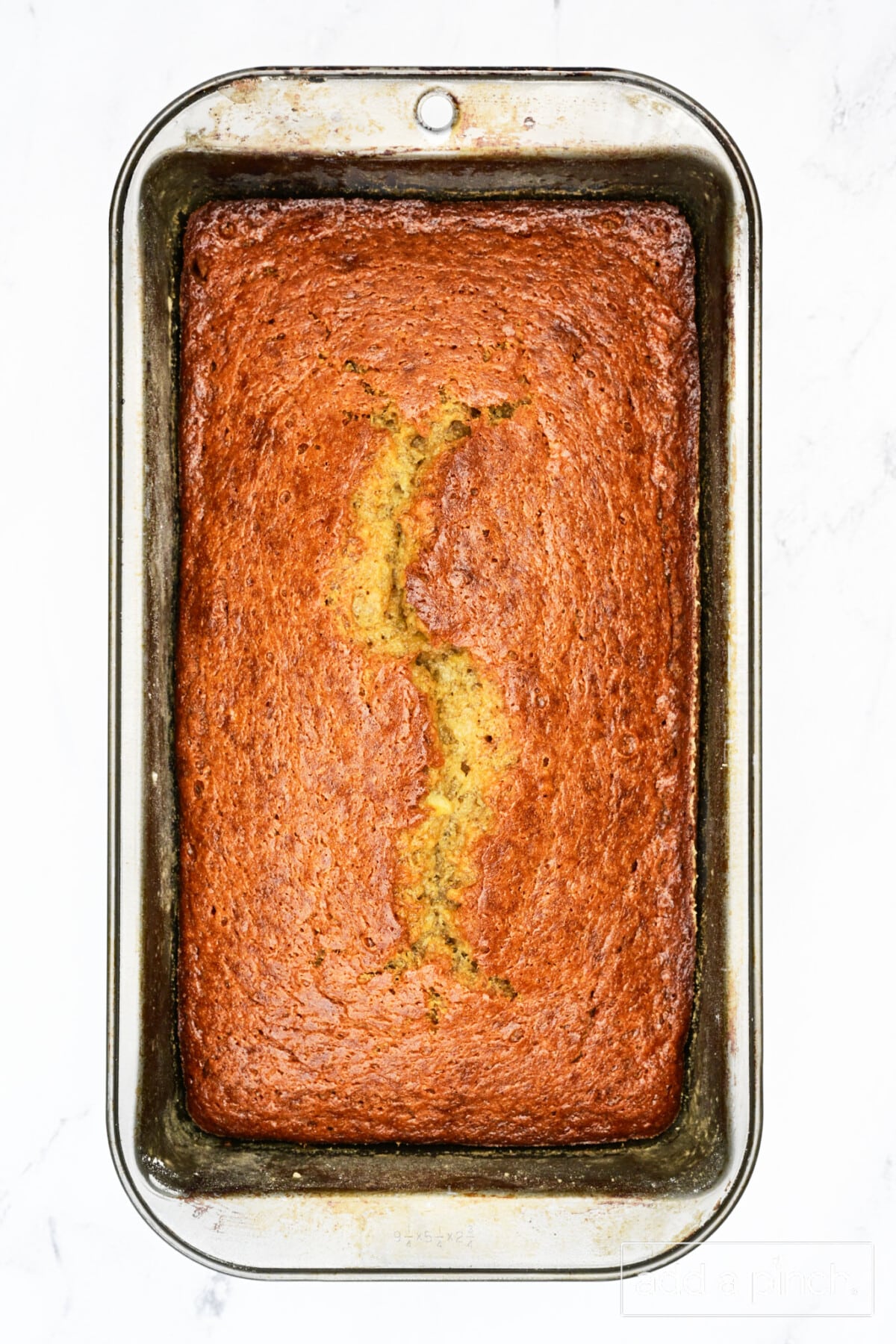 Golden brown freshly baked banana bread just removed from the oven.
