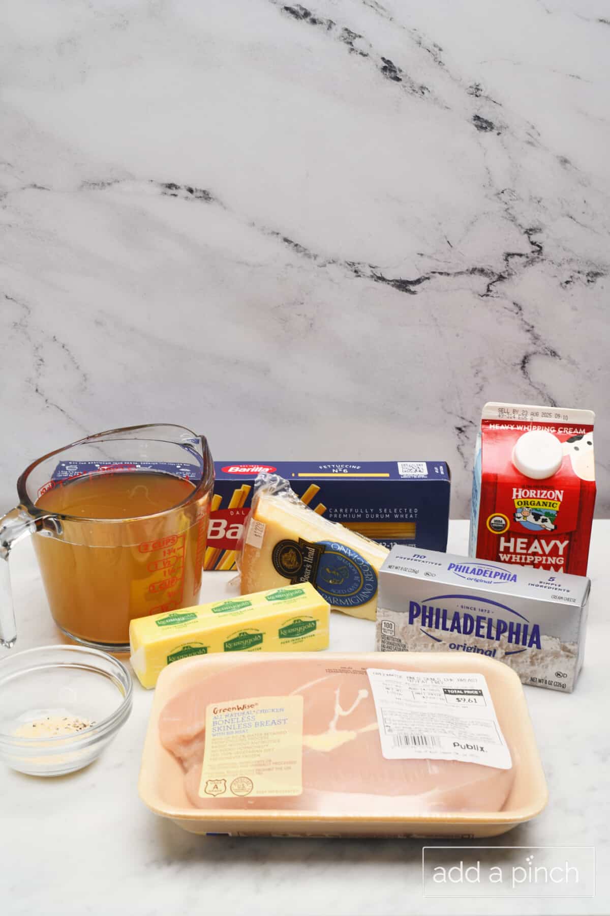 Ingredients used to make Instant Pot Chicken Alfredo including: chicken, cream cheese, butter, cream, chicken broth, cheese, and noodles.