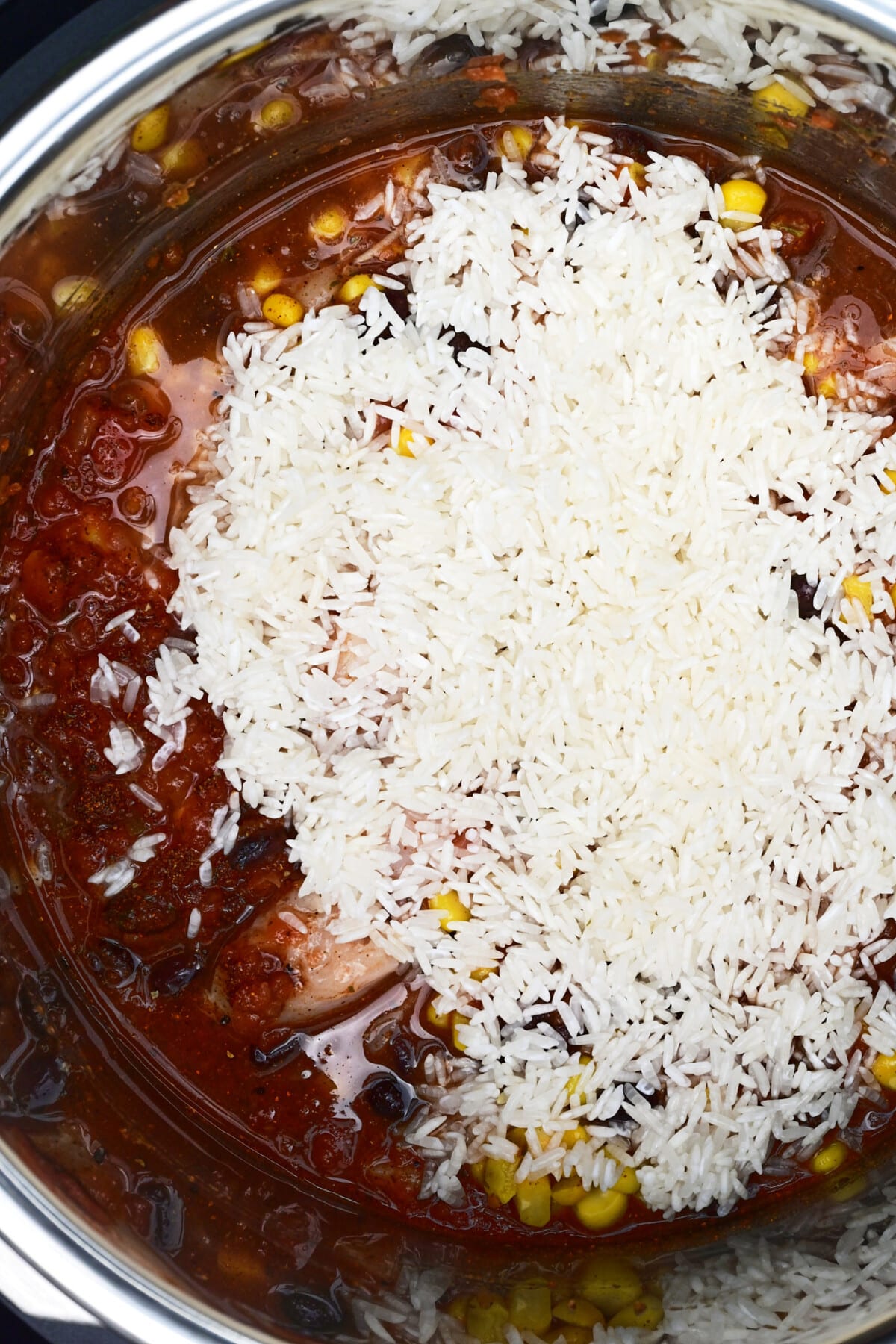 Rice added to Instant Pot for chicken burrito bowls.