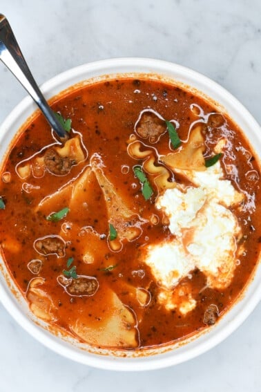 Bowl of easy lasagna soup recipe in a white bowl on a marble counter.