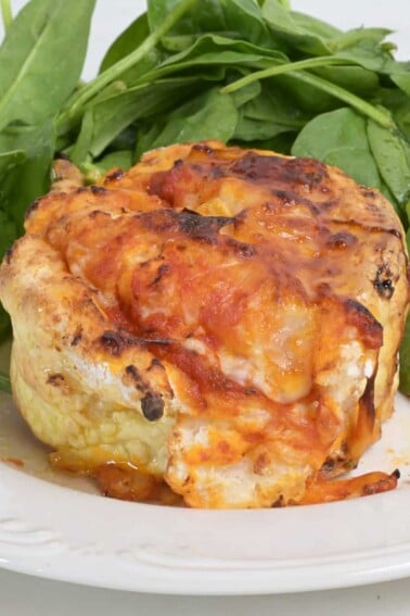 Homemade air fryer pizza rolls on a plate with spinach salad.