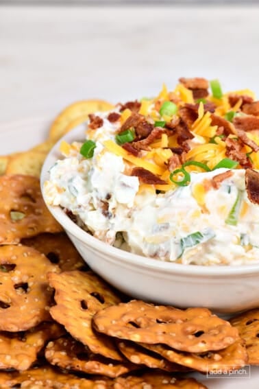 Bacon cheddar dip topped with cheese, bacon, and green onions.