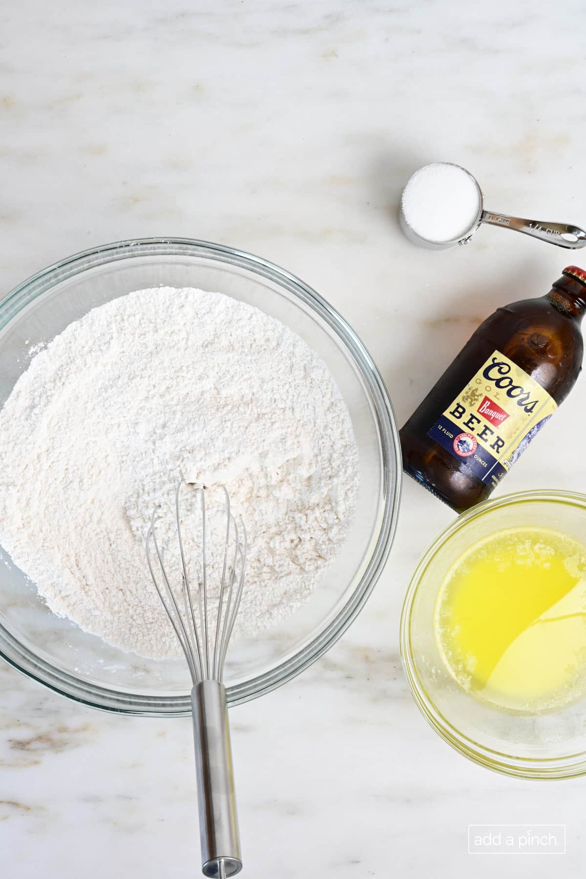 Ingredients used to make beer bread on a marble surface.