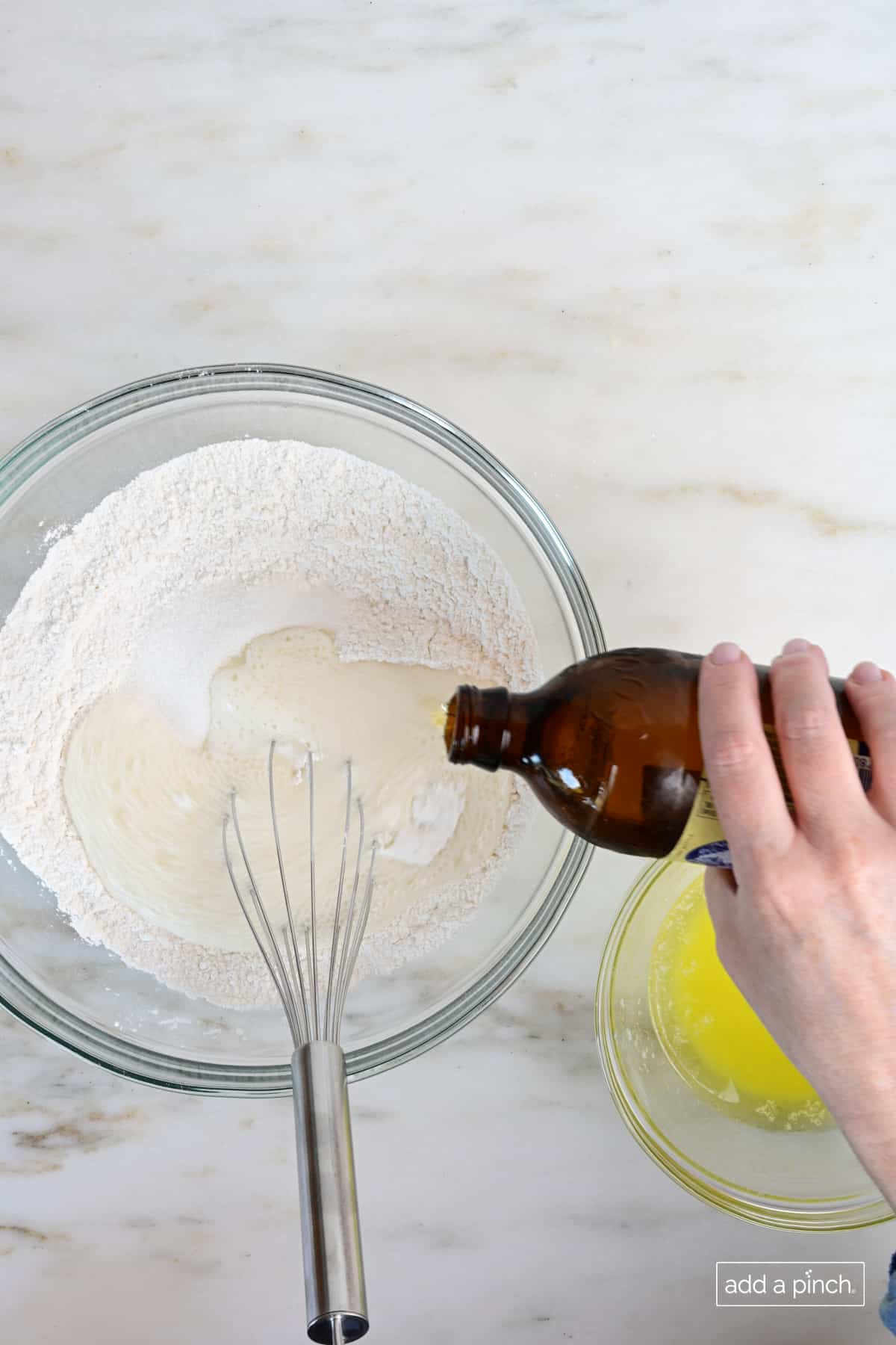 Flour and sugar in mixing bowl for beer bread.