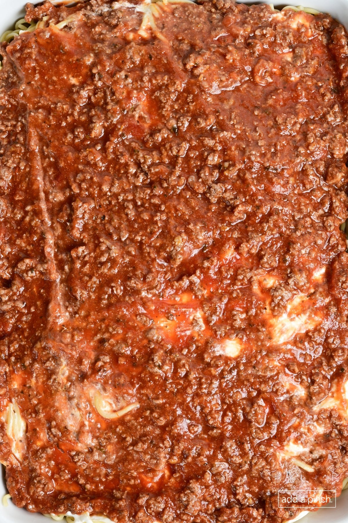 Meat sauce layer added to million dollar spaghetti casserole.