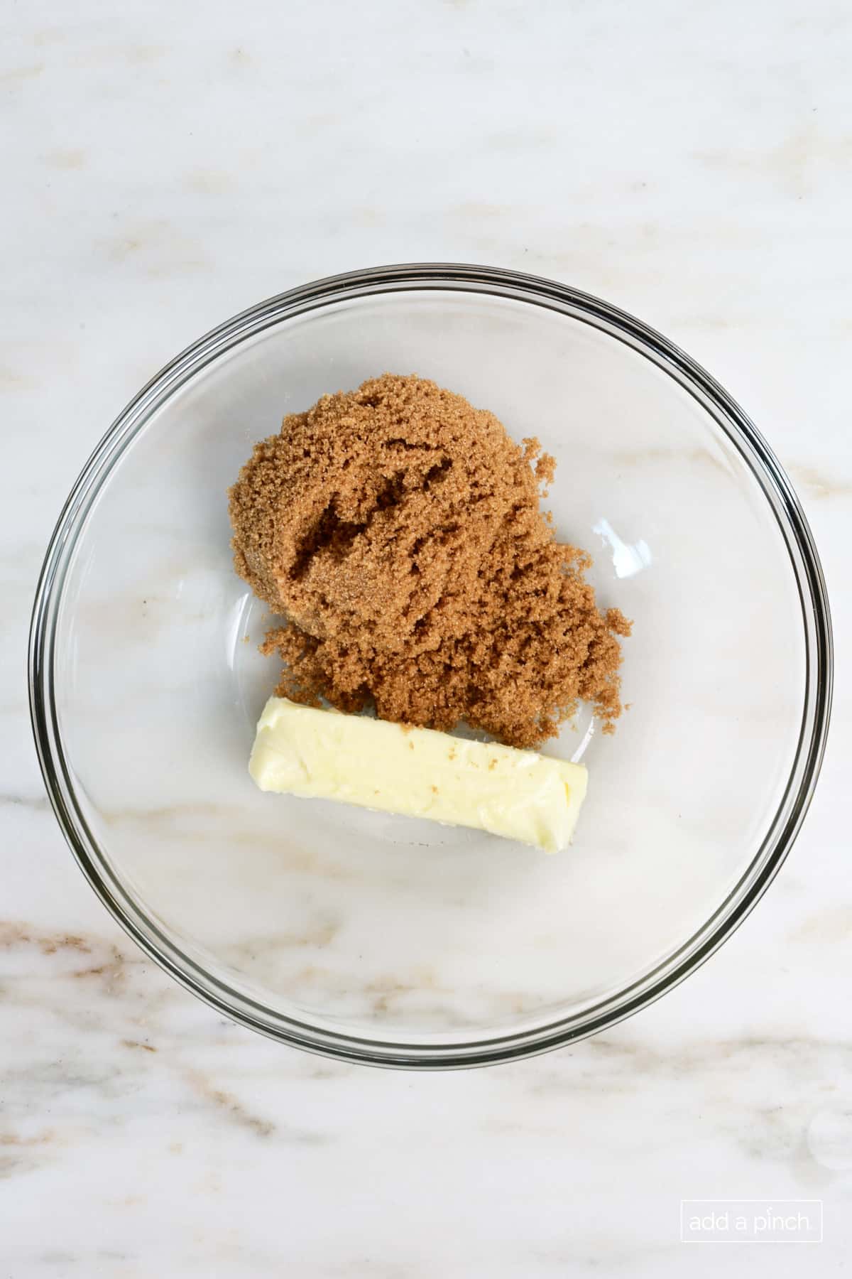 Brown sugar and butter in mixing bowl.