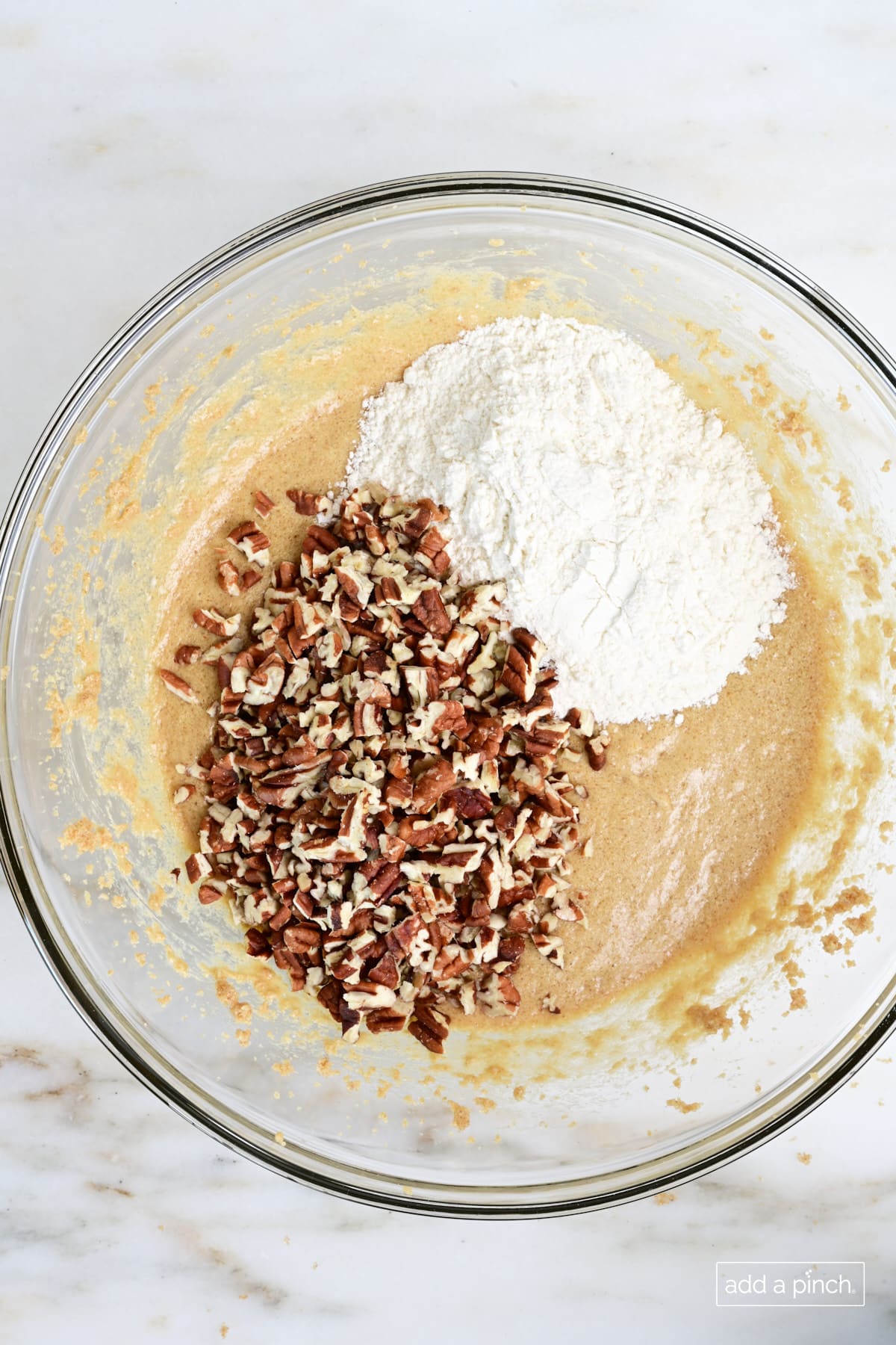 Flour and chopped pecans added to muffin batter.