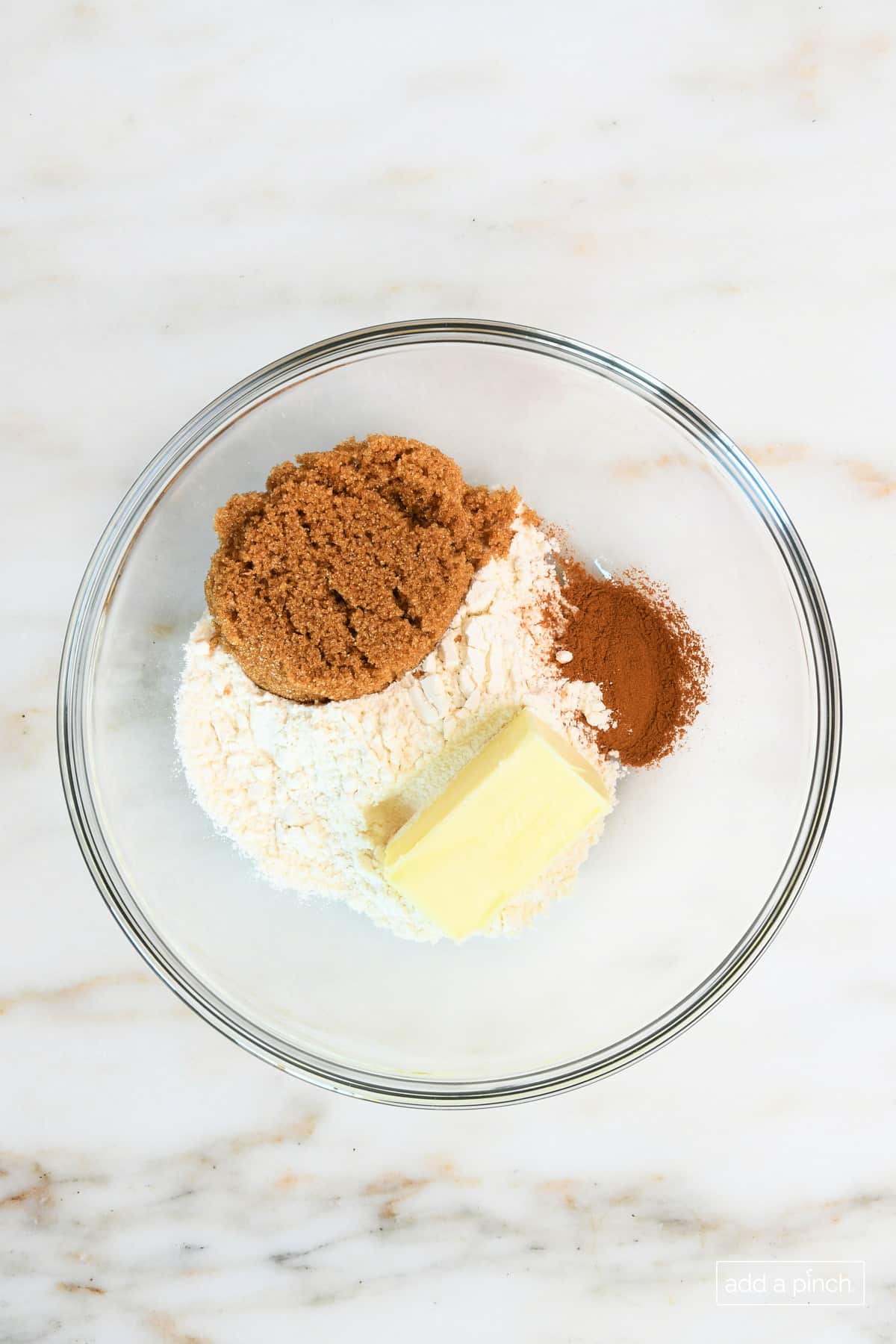 Crumble topping ingredients in a glass mixing bowl.