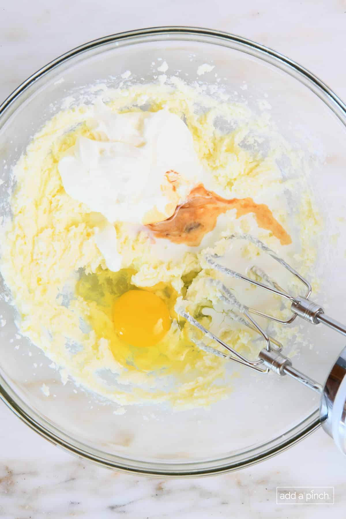 Add the egg, sour cream, milk, and vanilla extract.
