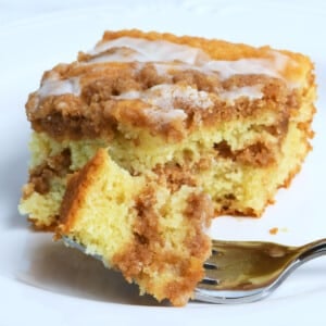 Sour cream coffee cake on a plate with fork.