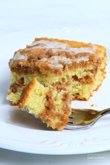 Sour cream coffee cake on a plate with fork.