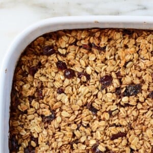 Baked Oatmeal in a white baking dish on a marble surface.