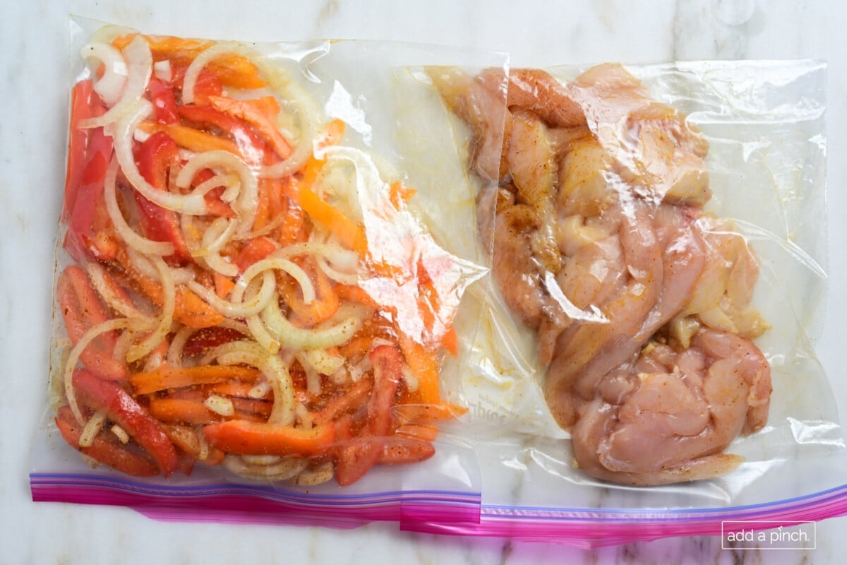 Bag of peppers and onions in marinade along with bag of chicken in marinade to make fajitas.