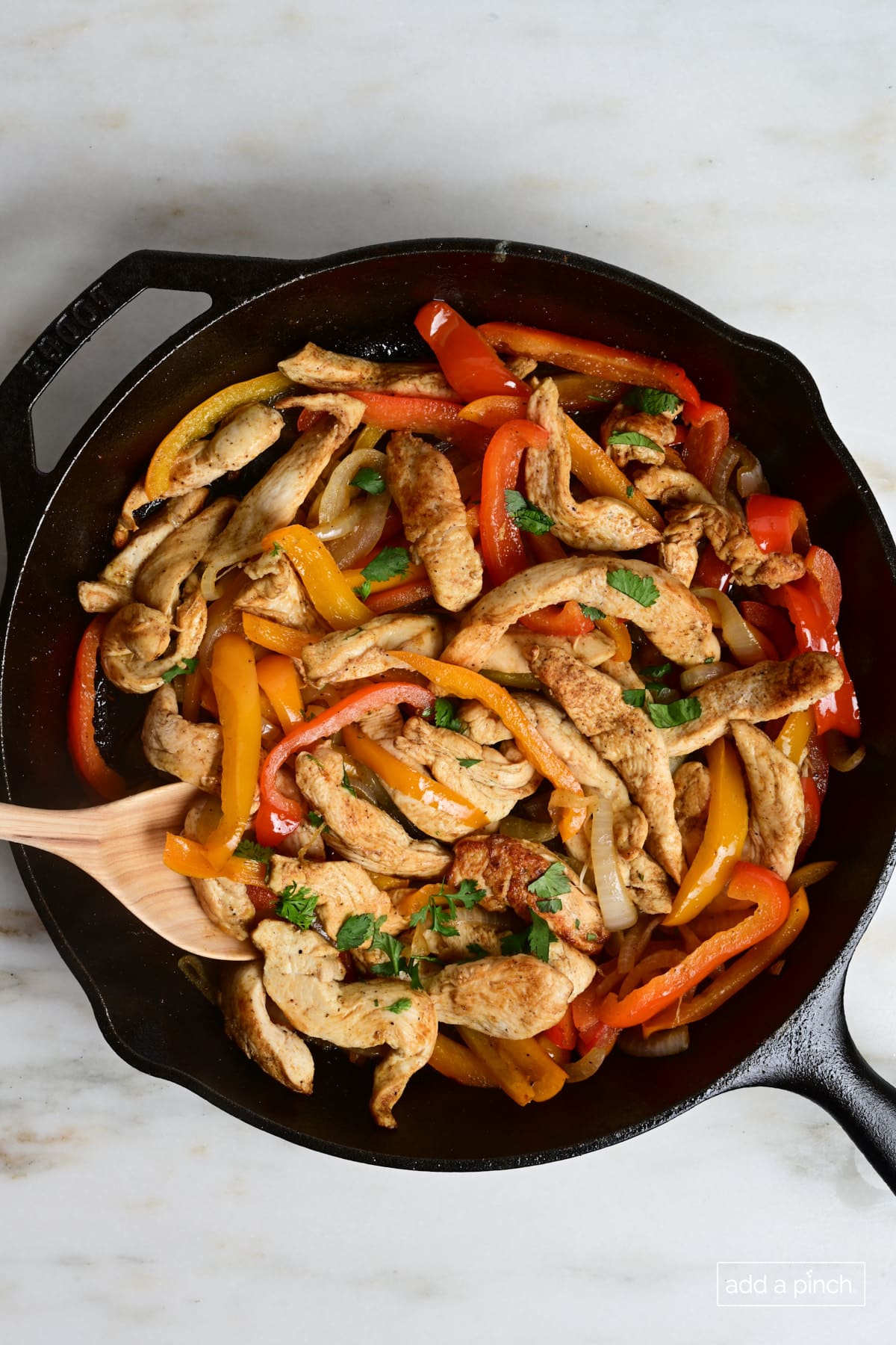 Cast iron skillet used to cook chicken fajitas.