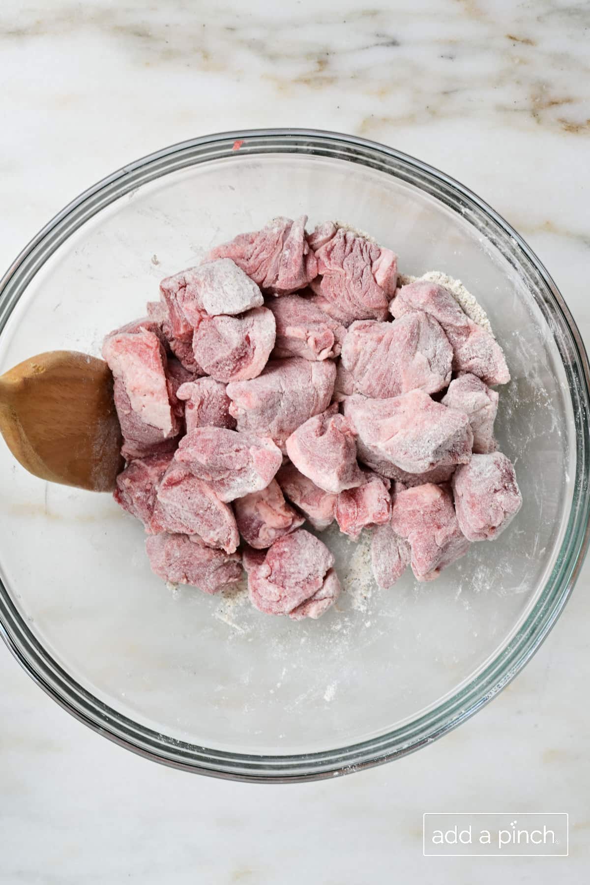 Lamb meat coated in seasoned flour ready to be browned for Irish Stew.