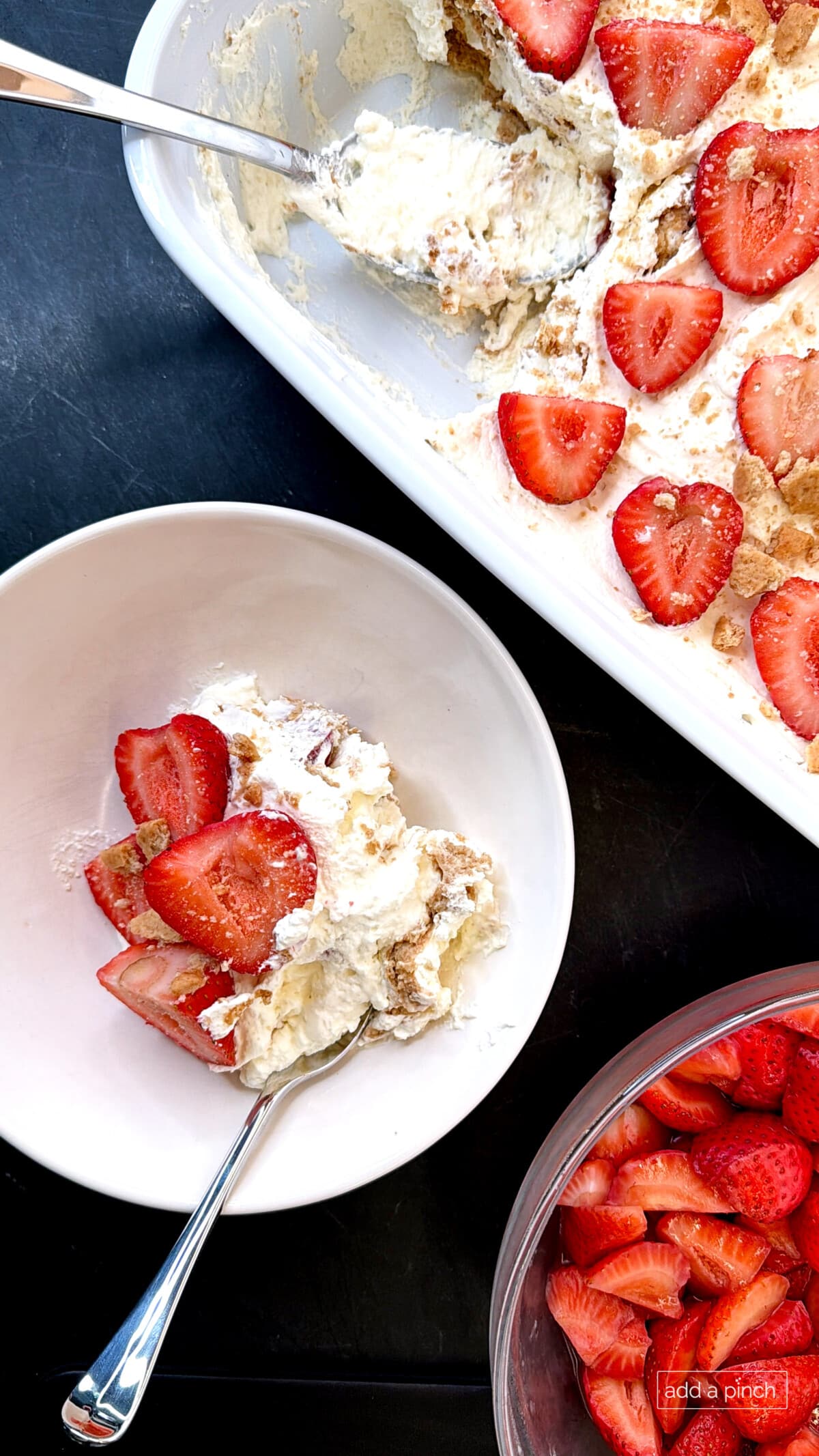 Freshly chilled no-bake Strawberry Icebox Cake presented in a white 9x13 baking dish, crowned with sweet strawberry slices on fluffy homemade whipped cream. Light, creamy, and bursting with fresh berry flavor — the perfect easy summer dessert.