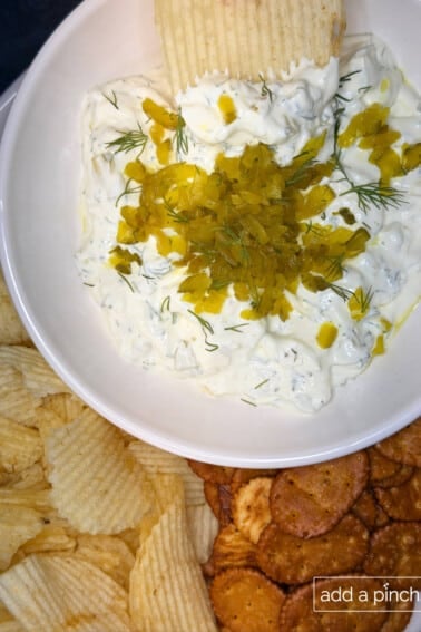 Creamy dill pickle dip served with chips, crackers, or veggies.