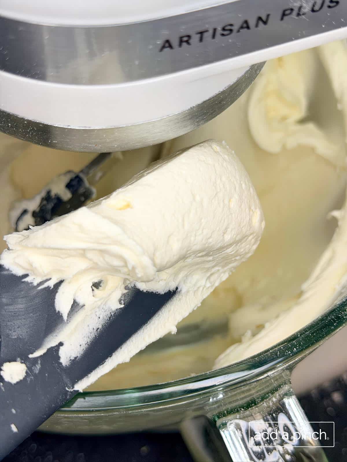 Creamy vanilla buttercream frosting on a spatula for the frosting layer of sugar cookie flag cake.