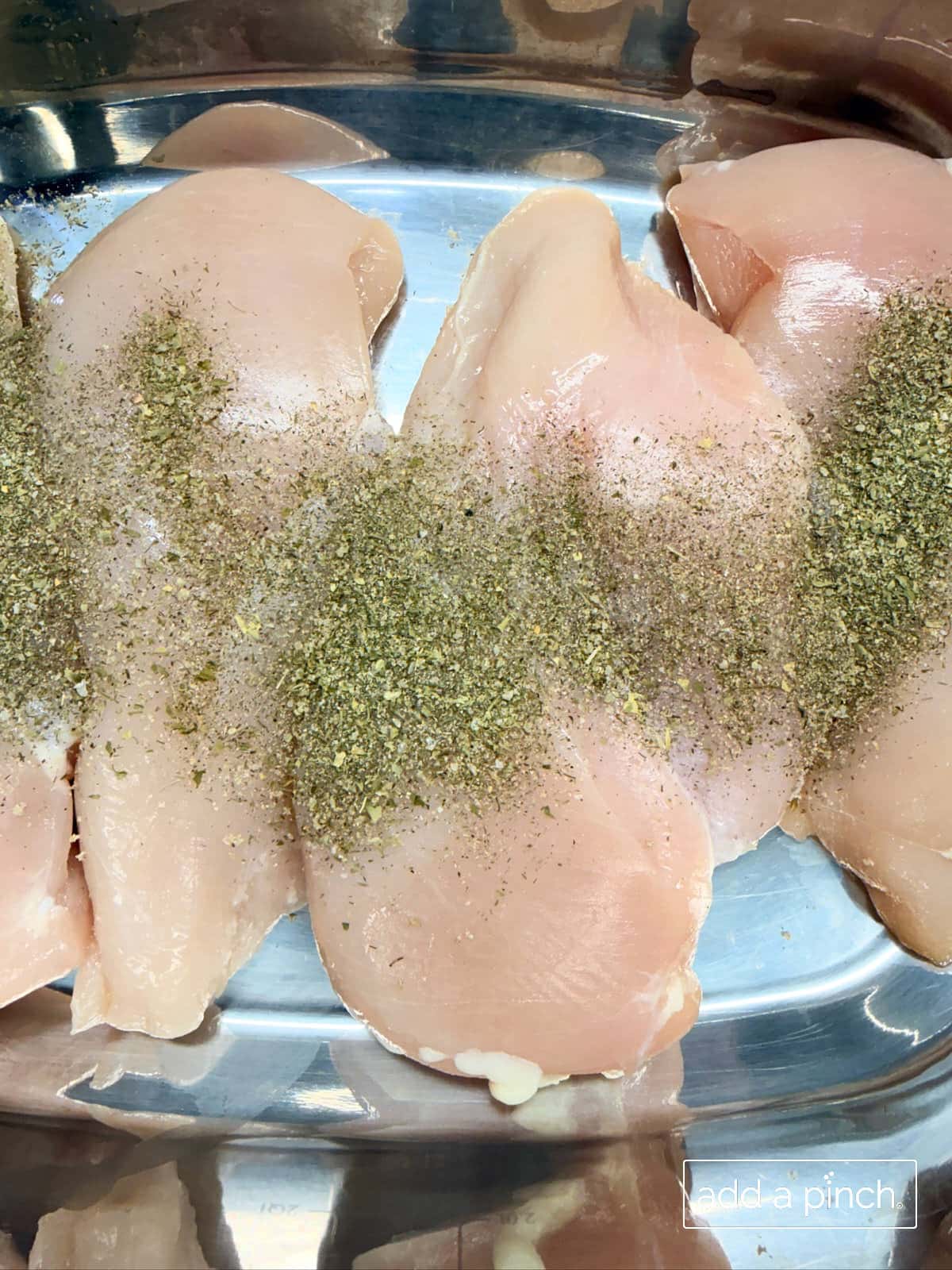 Chicken breasts sprinkled with ranch seasoning.