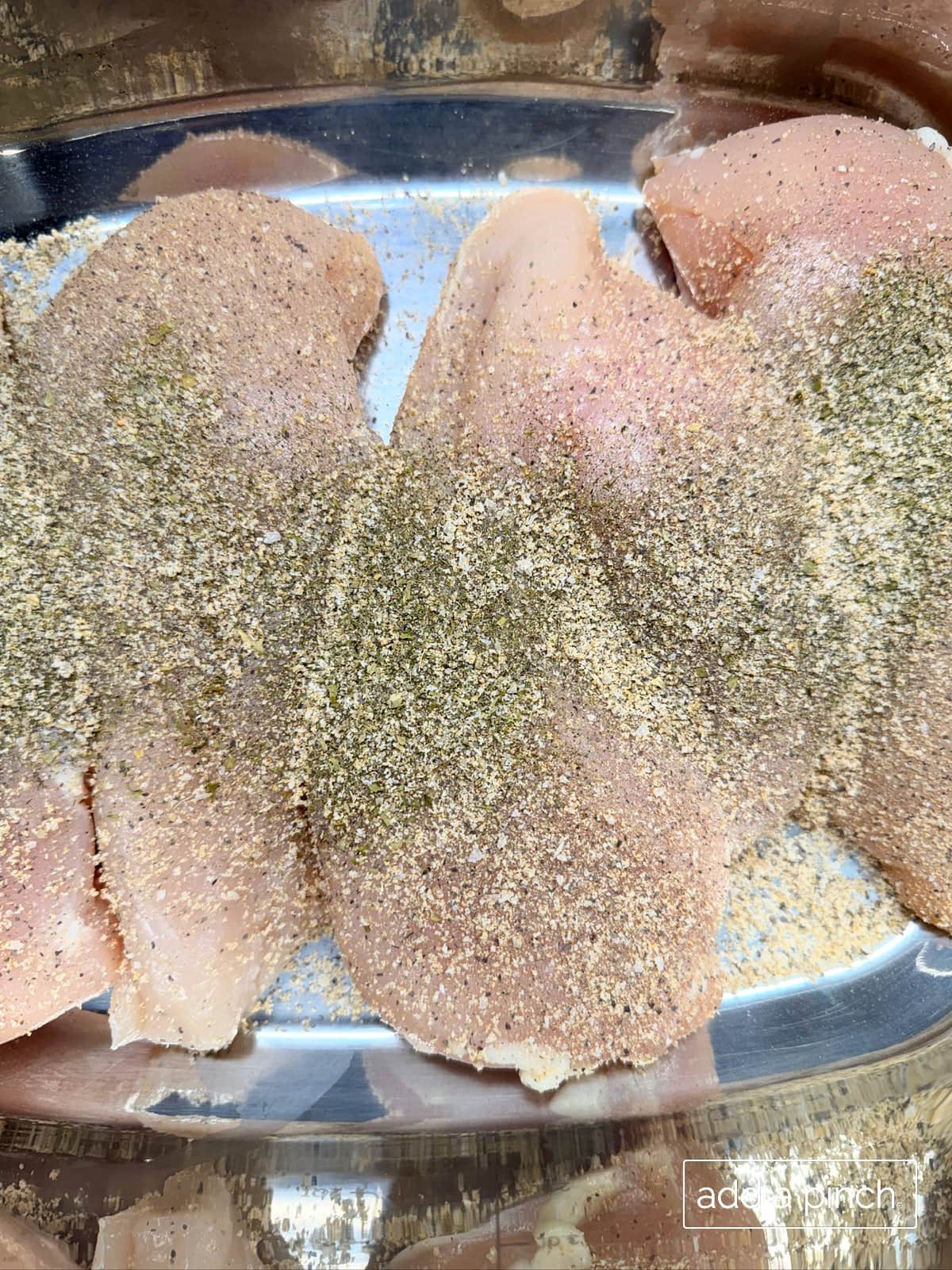 Chicken breasts with ranch seasoning and stone house seasoning sprinkled over top.